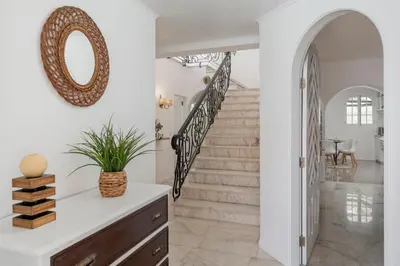 a staircase in a home with a mirror on the wall at OurMadeira - BelleVeva in Funchal