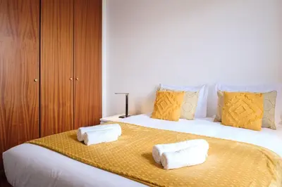 a bedroom with a large bed with towels on it at GuestReady - Tranquil Nest in Funchal in Funchal