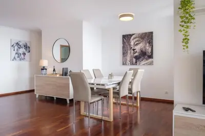 a dining room with a table and chairs and a mirror at GuestReady - Tranquil Nest in Funchal in Funchal