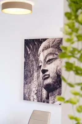 a picture of the head of a statue on a wall at GuestReady - Tranquil Nest in Funchal in Funchal