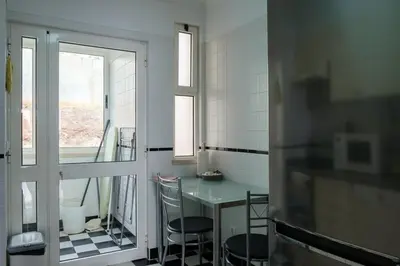 a kitchen with a table and chairs and a window at GuestReady - Tranquil Nest in Funchal in Funchal