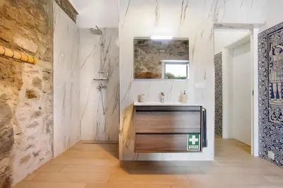 a bathroom with a sink and a mirror at Quinta Alcaparras in Porto Santo