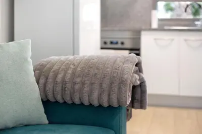a blanket on the back of a couch in a kitchen at Casa De Pedra in Porto Santo