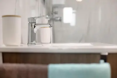 a kitchen counter with a faucet and a sink at Casa De Pedra in Porto Santo