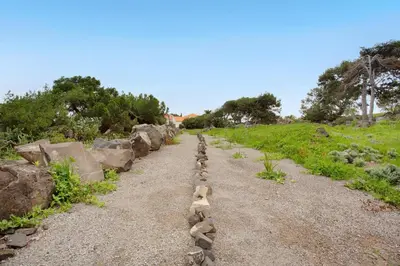 a row of rocks on a dirt road at Casa De Pedra in Porto Santo