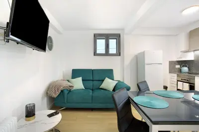 a living room with a blue couch and a table at Casa De Pedra in Porto Santo
