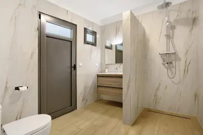 a bathroom with a sink and a mirror at Casa Do Vinho in Porto Santo