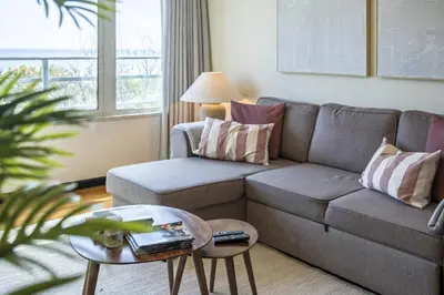 a living room with a couch and a table at Lavender - By Wehost in Funchal