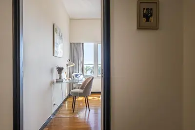 a door leading into a room with a chair and a desk at Lavender - By Wehost in Funchal