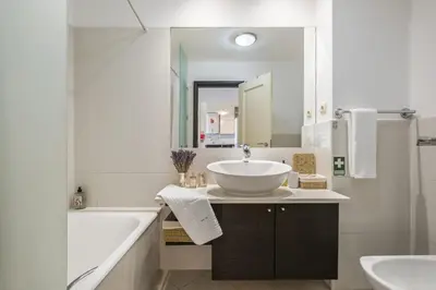 a white bathroom with a sink and a mirror at Lavender - By Wehost in Funchal