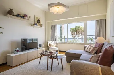 a living room with a couch and a tv at Lavender - By Wehost in Funchal