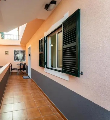 a hallway with windows and a tiled floor at Fisherman's house in Porto Moniz