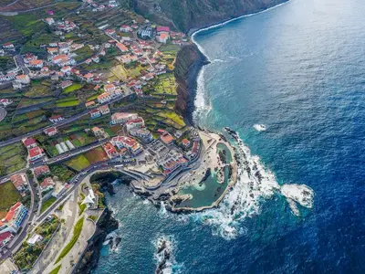an aerial view of a town next to the ocean at Fisherman's house in Porto Moniz