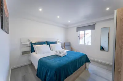 a bedroom with a bed with a blue blanket at Ocean Breeze in Porto Moniz