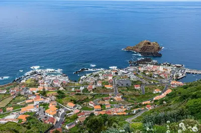 a group of people on the beach near the ocean at Ocean Breeze in Porto Moniz