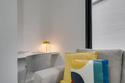 a living room with a couch and a table with a lamp at Graça House in Machico