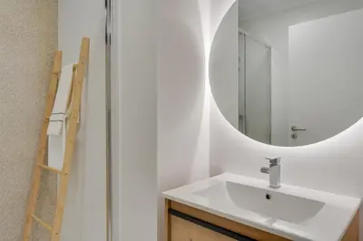 a bathroom with a sink and a mirror at Graça House in Machico