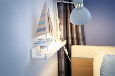 a toy boat on a shelf next to a bed at Charming traditional house in tiny, cozy village in Vale de Boi