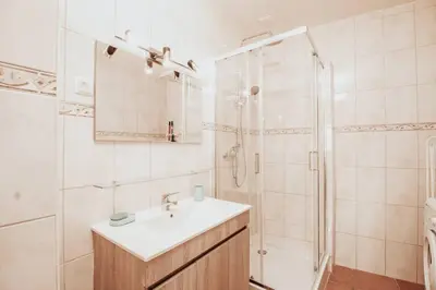 a white bathroom with a sink and a shower at Charming traditional house in tiny, cozy village in Vale de Boi