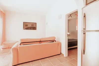 a living room with a couch and a refrigerator at Charming traditional house in tiny, cozy village in Vale de Boi