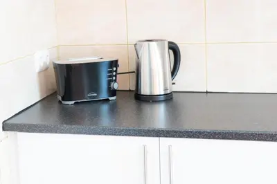 a toaster and coffee maker on a kitchen counter at Charming traditional house in tiny, cozy village in Vale de Boi