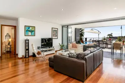 a living room with a couch and a television at Villa Sol e Mar by Villa Plus in Caniço