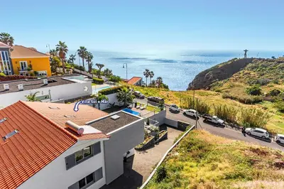 an aerial view of a house and the ocean at Villa Sol e Mar by Villa Plus in Caniço