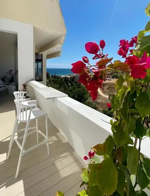 a white balcony with a view of the ocean at Ocean Studio by ENDLESS SUN I modern comfort, sea view, wi-fi, parking, rooftop pool in Lagos