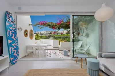 a living room with a view of a garden at Ocean Studio by ENDLESS SUN I modern comfort, sea view, wi-fi, parking, rooftop pool in Lagos