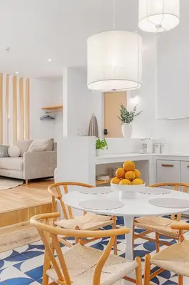 a kitchen and living room with a table and chairs at Ocean Studio by ENDLESS SUN I modern comfort, sea view, wi-fi, parking, rooftop pool in Lagos