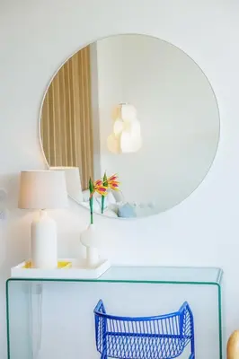 a table with a blue chair and a mirror at Ocean Studio by ENDLESS SUN I modern comfort, sea view, wi-fi, parking, rooftop pool in Lagos