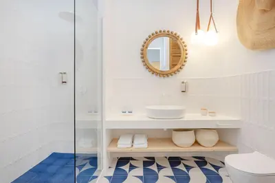 a bathroom with a sink and a mirror at Ocean Studio by ENDLESS SUN I modern comfort, sea view, wi-fi, parking, rooftop pool in Lagos