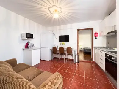 a living room with a couch and a kitchen at GuestReady - Machico sea view residence - B in Machico