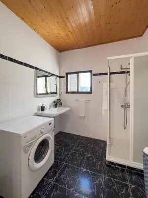 a bathroom with a washing machine and a shower at GuestReady - Machico sea view residence - B in Machico