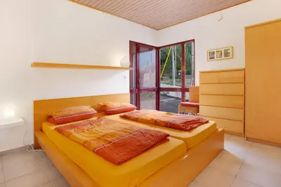 two beds in a room with a window at Casa Conny in Caniço