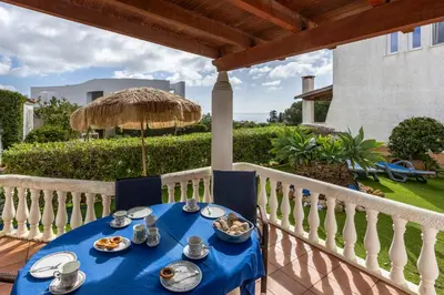 a blue table with food on a balcony at Seaside Retreat Casa Romana in Luz