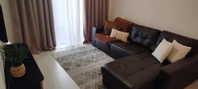 a living room with a brown leather couch and a window at Apartamento Quitéria - Funchal in Funchal