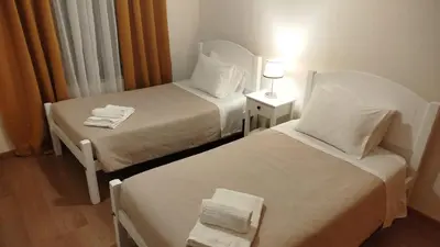 a hotel room with two beds and a lamp at Apartamento Quitéria - Funchal in Funchal