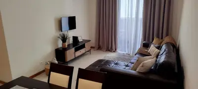 a living room with a couch and a television at Apartamento Quitéria - Funchal in Funchal