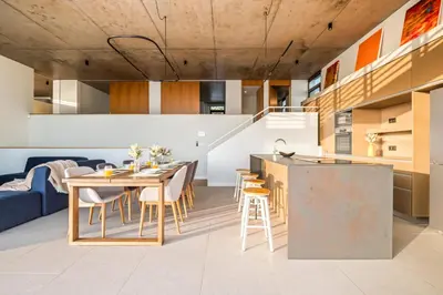 a kitchen and dining room with a table and chairs at Lake House in Calheta