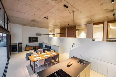 a kitchen and living room with a table and chairs at Lake House in Calheta