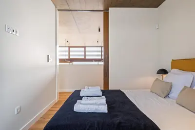 a bedroom with a bed with two towels on it at Lake House in Calheta