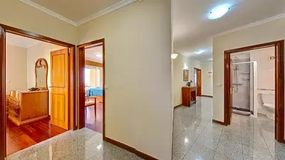 a living room with a hallway with a bathroom at Caniço Center Apartment in Caniço