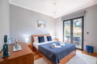 a bedroom with a bed and a large window at Yuri Big House in Ribeira Brava