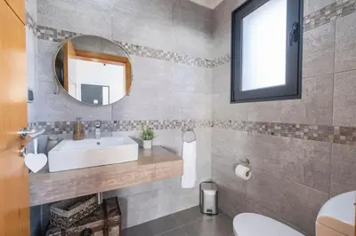 a bathroom with a sink and a mirror at Yuri Big House in Ribeira Brava