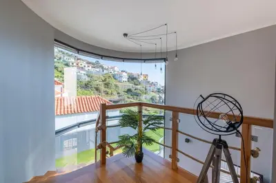 a room with a large window and a tripod at Yuri Big House in Ribeira Brava