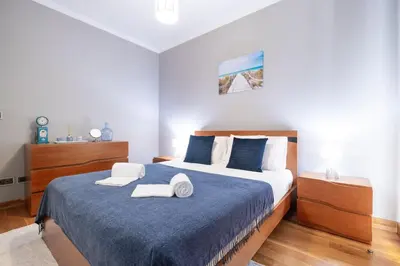 a bedroom with a bed with two towels on it at Yuri Big House in Ribeira Brava