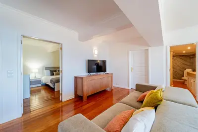 a living room with a couch and a bedroom at Ana's Place in Funchal