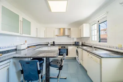 a kitchen with white cabinets and a counter top at Ana's Place in Funchal
