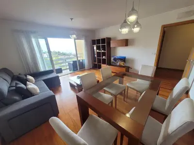 a living room with a couch and a table and chairs at Pilar Balconies in Funchal City in Funchal